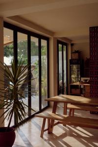 a room with two wooden tables and a potted plant at Soul Temple Boutique Hotel ADULTS ONLY in Ahangama
