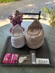 a tray with two towels and a packet of soap at Le Neuf Nakorn Lampang in Lampang