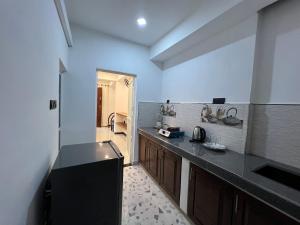 a kitchen with a black counter top in a room at Blue Mind Surf Home in Weligama +26 photos