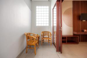 a room with two chairs and a table and a window at Cove Puspa Canggu in Canggu +22 photos