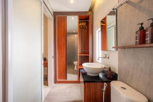 a bathroom with a sink and a toilet in it at Cove Puspa Canggu in Canggu