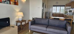 a living room with a couch and a kitchen at B43A1 Silverpark 4th floor Best Mountain view in Bukit Fraser +8 photos