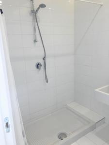 a white shower with a shower head in a bathroom at Casa Maria in Salerno