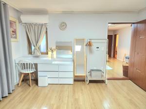 a bedroom with a desk and a chair and a mirror at 상무하우스 in Gwangju +47 photos