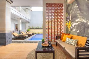 a living room with a couch and a table at Cove Puspa Canggu in Canggu