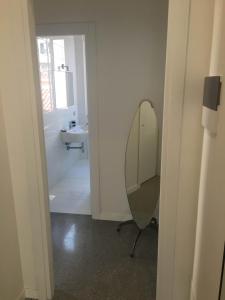 a bathroom with a mirror and a sink at Casa Maria in Salerno