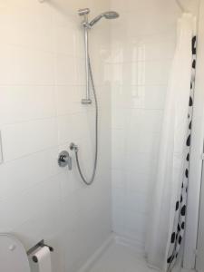 a white bathroom with a shower and a toilet at Casa Maria in Salerno