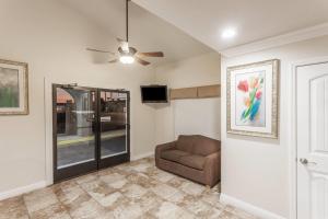 a living room with a couch and a ceiling fan at Travelodge by Wyndham Hemet CA in Hemet