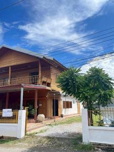 a house with a tree in front of it at Le Moon Hotel in Chiang Khan +54 photos