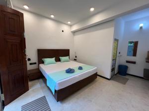 a bedroom with a large bed in a room at Blue Mind Surf Home in Weligama