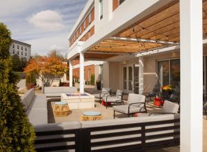 a patio with couches and tables on a building at Home2 Suites by Hilton Canton in North Canton