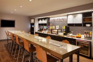 a long dining room with a long table and chairs at Home2 Suites by Hilton Canton in North Canton