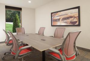 a conference room with a wooden table and chairs at Home2 Suites by Hilton Canton in North Canton +24 photos