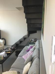 a living room with a couch and a staircase at Casa Maria in Salerno