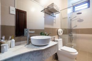 a bathroom with a sink and a toilet at Ngoc Nguyen Anh Hotel Da Lat in Da Lat
