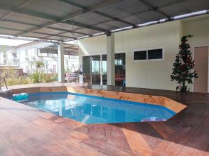 a swimming pool with a christmas tree in a house at Banyai Pool Villa Chiang Khan in Loei