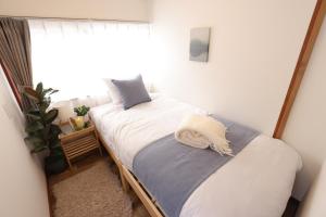 En eller flere senge i et værelse på Myoko Home