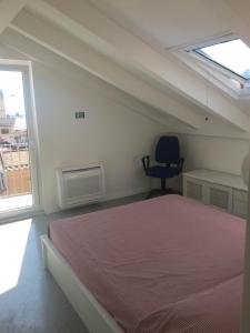 a bedroom with a bed and a desk and a chair at Casa Maria in Salerno