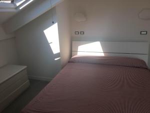 a bedroom with a bed and a window at Casa Maria in Salerno