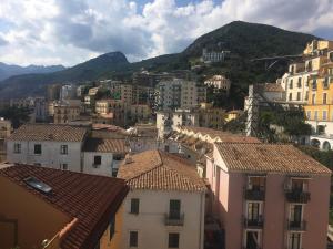 a view of a city with buildings and mountains at Casa Maria in Salerno