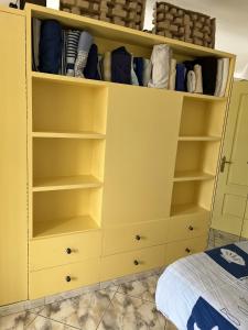 a yellow closet with shelves and a bed at El Alba in San Bartolomé de Tirajana