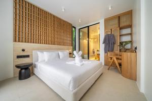 a bedroom with a bed with a white bunny on it at Ardhana Villas - Luxury Pool Stay with Scenic Views in Ungasan