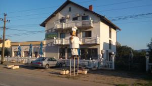 a building with a teddy bear on the side of it at Laguna Guesthouse in Bela Crkva