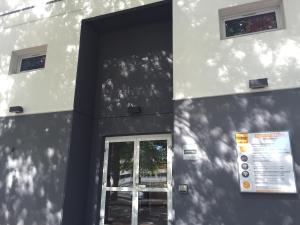 a building with a door and a window on it at Première Classe Rennes sud Est in Chantepie