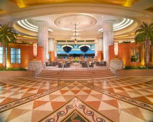 a lobby with a large lobby with chairs and tables at Grand Hyatt Dubai Resort & Waterpark in Dubai