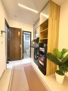 a kitchen with a washer and dryer in a room at Cozy Homestay Tây Mỗ in Phú Thú