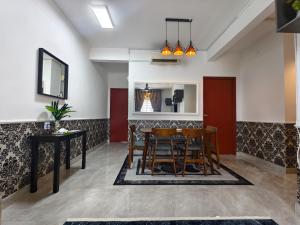 a dining room with a table and chairs at Cocasa Homestay 1 in Kuala Terengganu