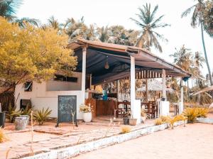 a restaurant with a sign in front of a building at Kiteclub in Kalpitiya