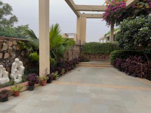 a walkway in a garden with plants and flowers at Minimalist Escape in Gurgaon