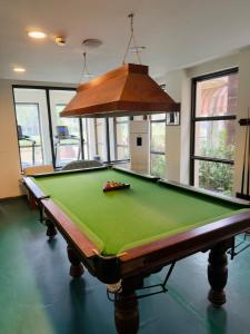 a pool table in a living room with at Minimalist Escape in Gurgaon +9 photos