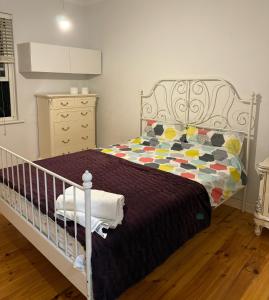 a bedroom with a bed with a purple blanket at Avenue rd Clarence Gardens in Clarence Park