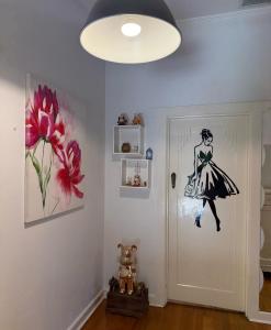 a room with a painting of a woman on the door at Avenue rd Clarence Gardens in Clarence Park