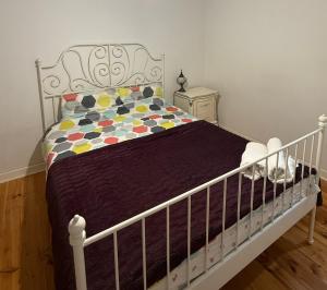 a bedroom with a white crib with a bedspread at Avenue rd Clarence Gardens in Clarence Park