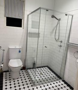 a bathroom with a shower and a toilet at Avenue rd Clarence Gardens in Clarence Park