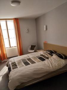 a bedroom with a large bed and a window at Hôtel le beau séjour in Sainte-Suzanne