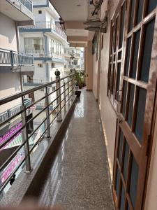 een lege gang in een appartementencomplex met water op de grond bij Hathayogashram Hostel in Rishīkesh