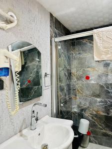 a bathroom with a sink and a shower at Fİi SUİTES in Kumluca +3 photos