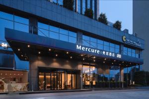 a store front of a building with a sign on it at Mercure Nanjing Olympic EXPO in Nanjing