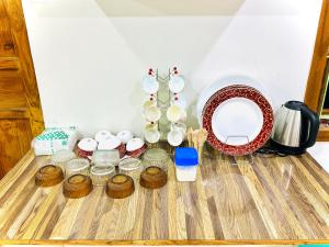 a group of dishes and bowls on a table at P V J RESIDENCY Home Stay in Pithāpuram +15 photos