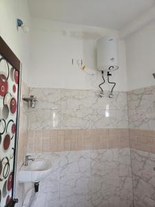 a bathroom with a sink and a toilet in it at Pandit Devki Nandan Dharamsala & Guest House in Deoghar