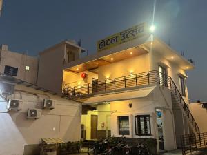 a building with a balcony on the side of it at Hotel Utsav in Khatīma