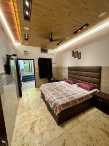 a bedroom with a large bed in a room at Hotel Utsav in Khatīma