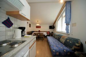 a kitchen with a couch and a table in a room at Apart Fortuna in Samnaun