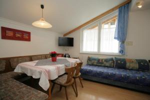 a living room with a table and a couch at Apart Fortuna in Samnaun