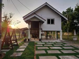 a small white house with a playground in front of it at Tokpa Tokma's Haven in Jertih