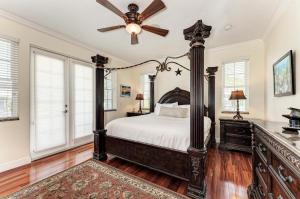 een slaapkamer met een groot bed en een plafondventilator bij Villa Di Palma 5BD 4BR in Anna Maria +68 foto's